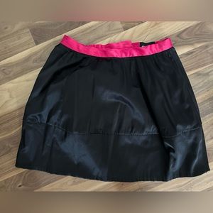 Black silk skirt with pink ribbon top.